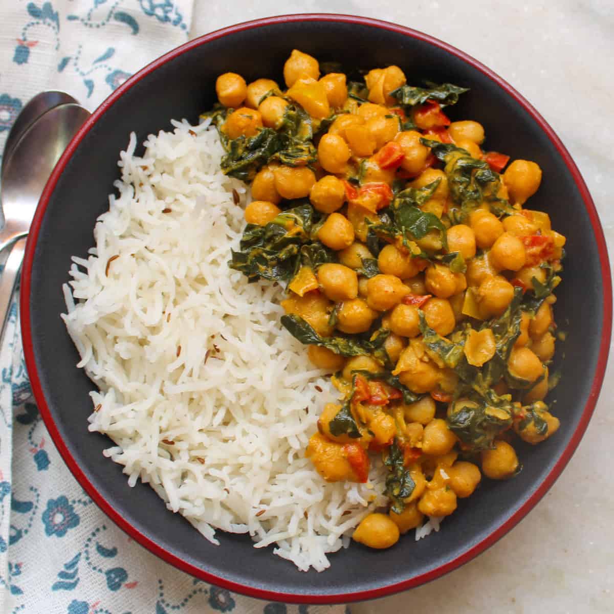 Bowl of basmati rice served with chickpea kale curry.