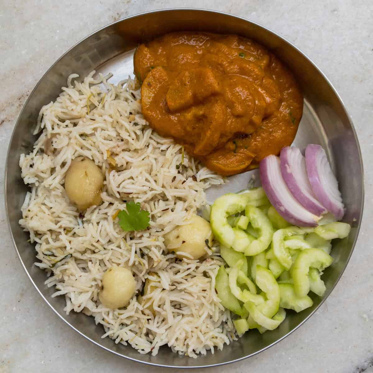 Potato rice with zucchini curry, onion, and cucumber salad.