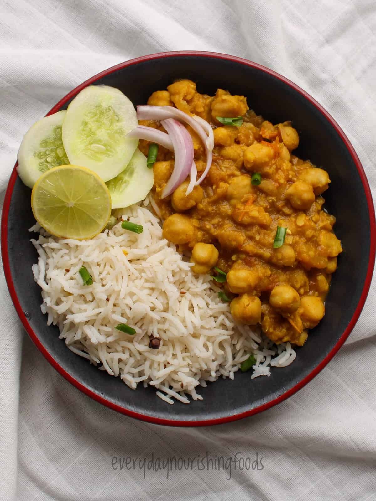 chickpea curry with basamati rice and salad in a plate