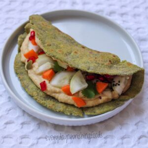 spinach tortilla wrap with hummus in a plate