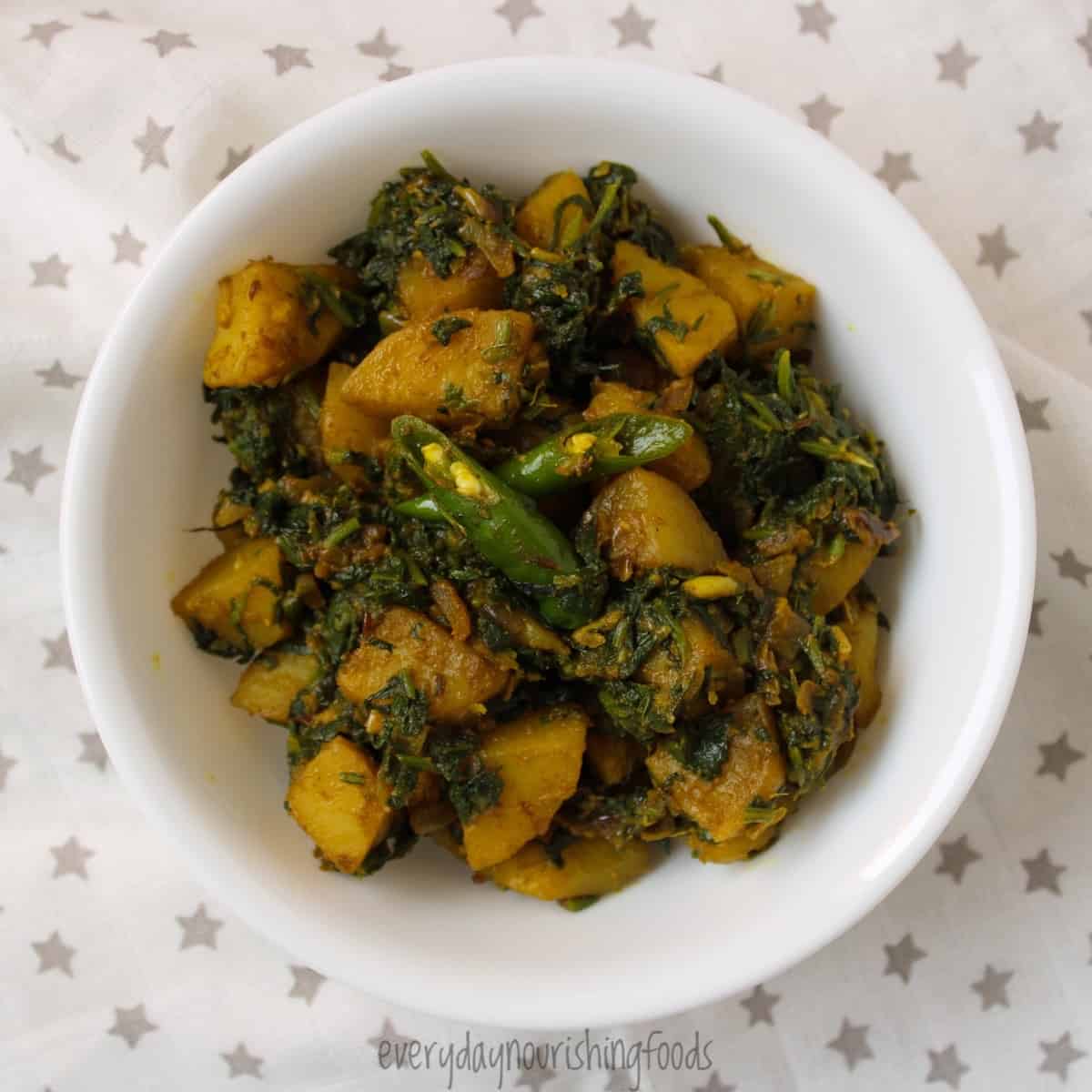 spinach and potato curry in a bowl