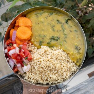 cooked millet with red lentil dal and veggie salad