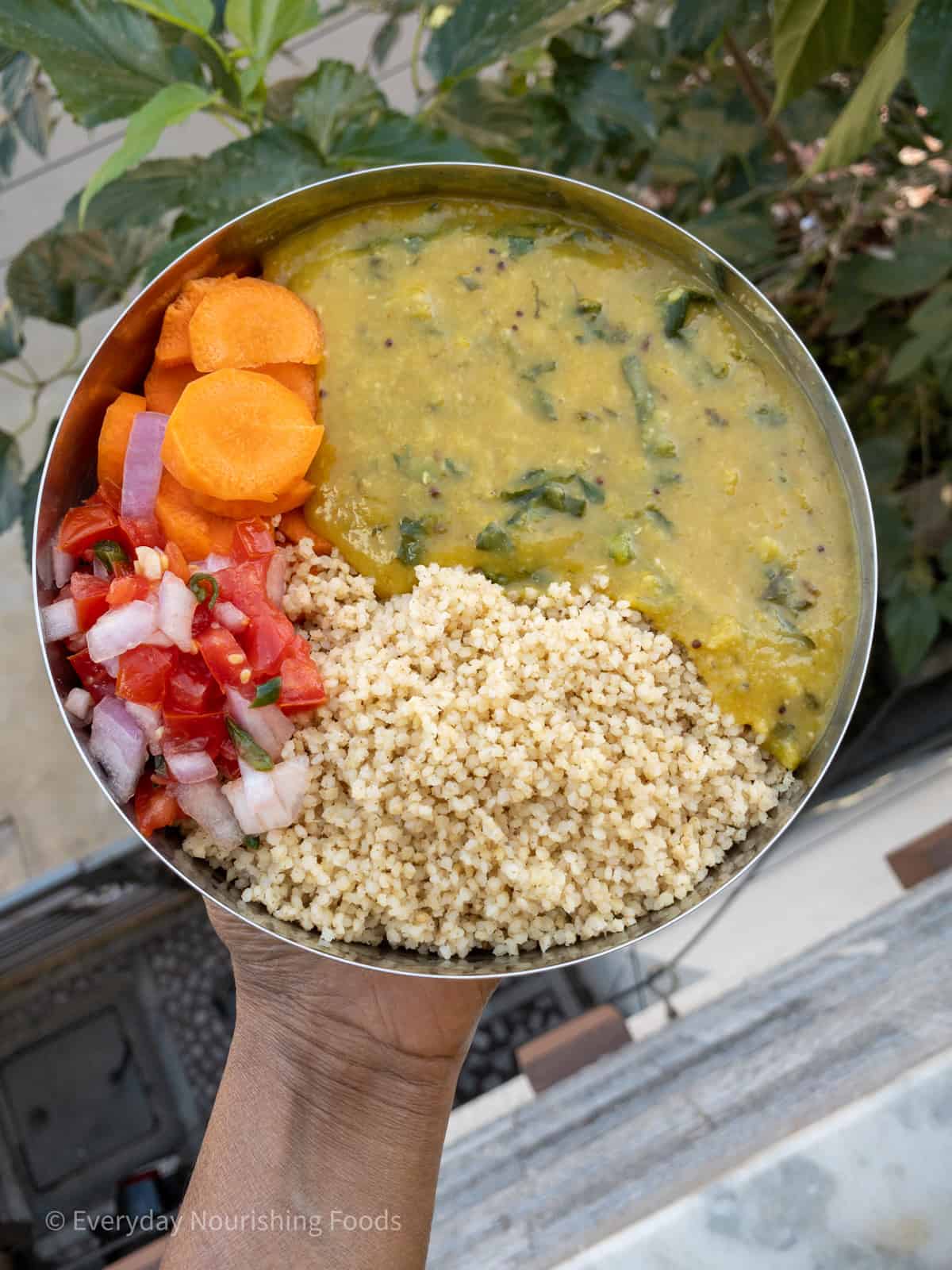 cooked millet with red lentil dal and veggie salad