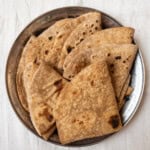 Close-up of soft and perfectly cooked Indian bread chapati, served in a steel plate.