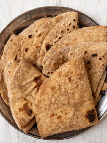 Close-up of soft and perfectly cooked Indian chapati, served in a steel plate.