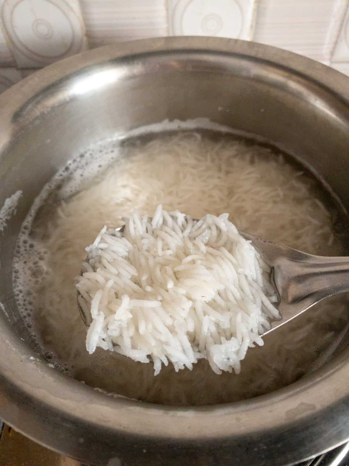 Straining basmati rice after boiling in excess water.
