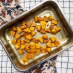 Top view of roasted butternut squash with golden edges in a pan, ready to serve as a flavorful Indian-style side dish.