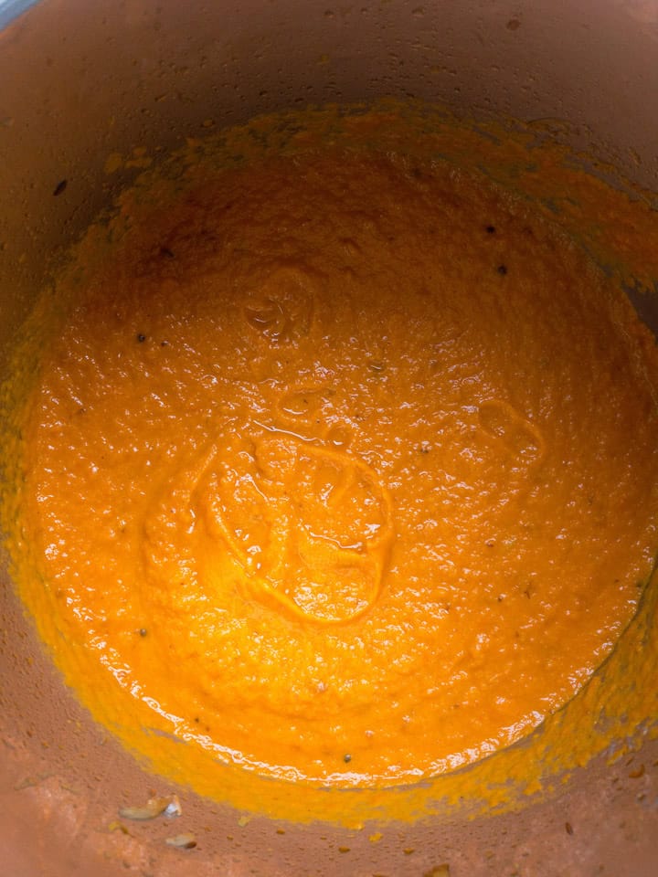 Smooth blended curry sauce coating the bottom of the Instant Pot insert.