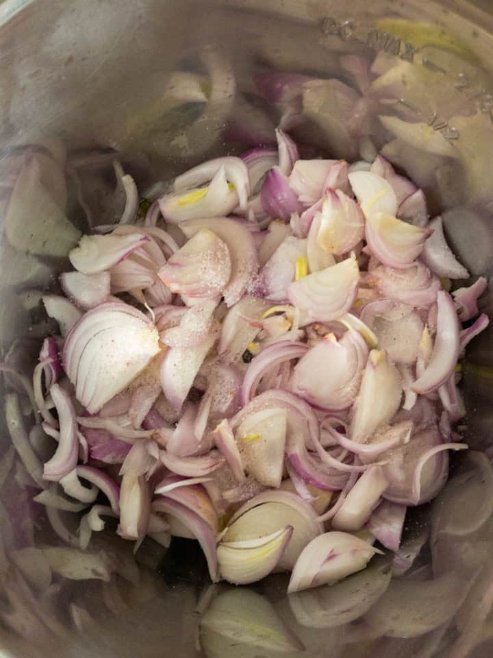 Sliced red onions and salt just added to the pot for sautéing.