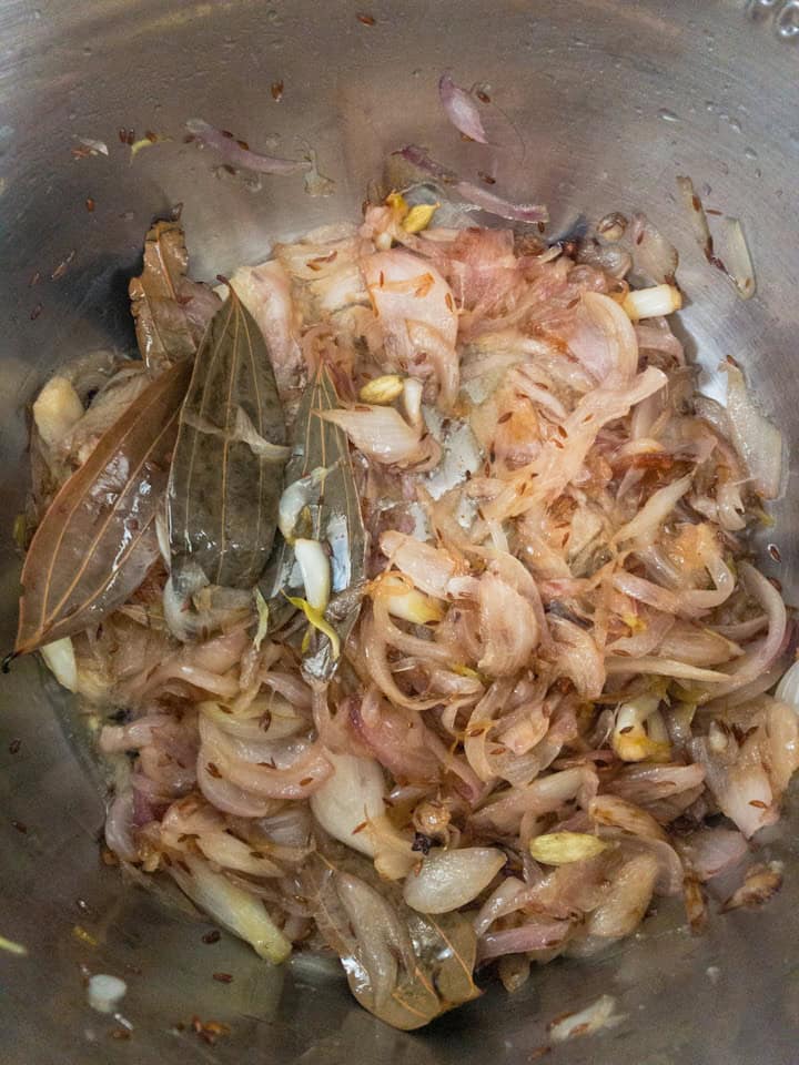 Onions caramelised to golden brown with whole spices visible.