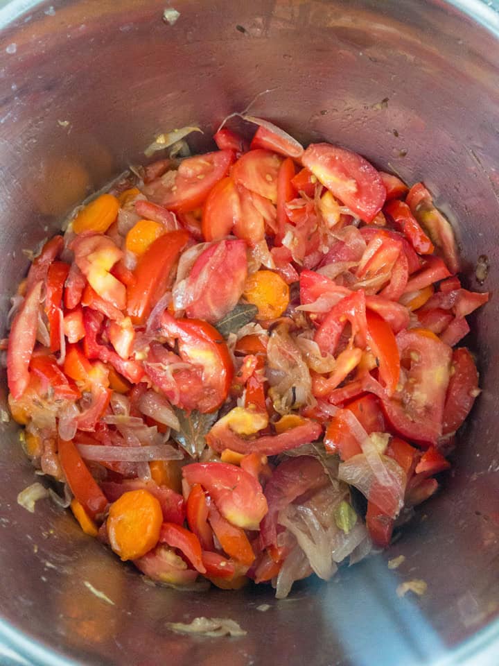 Vegetables stirred together, starting to soften and release juices.