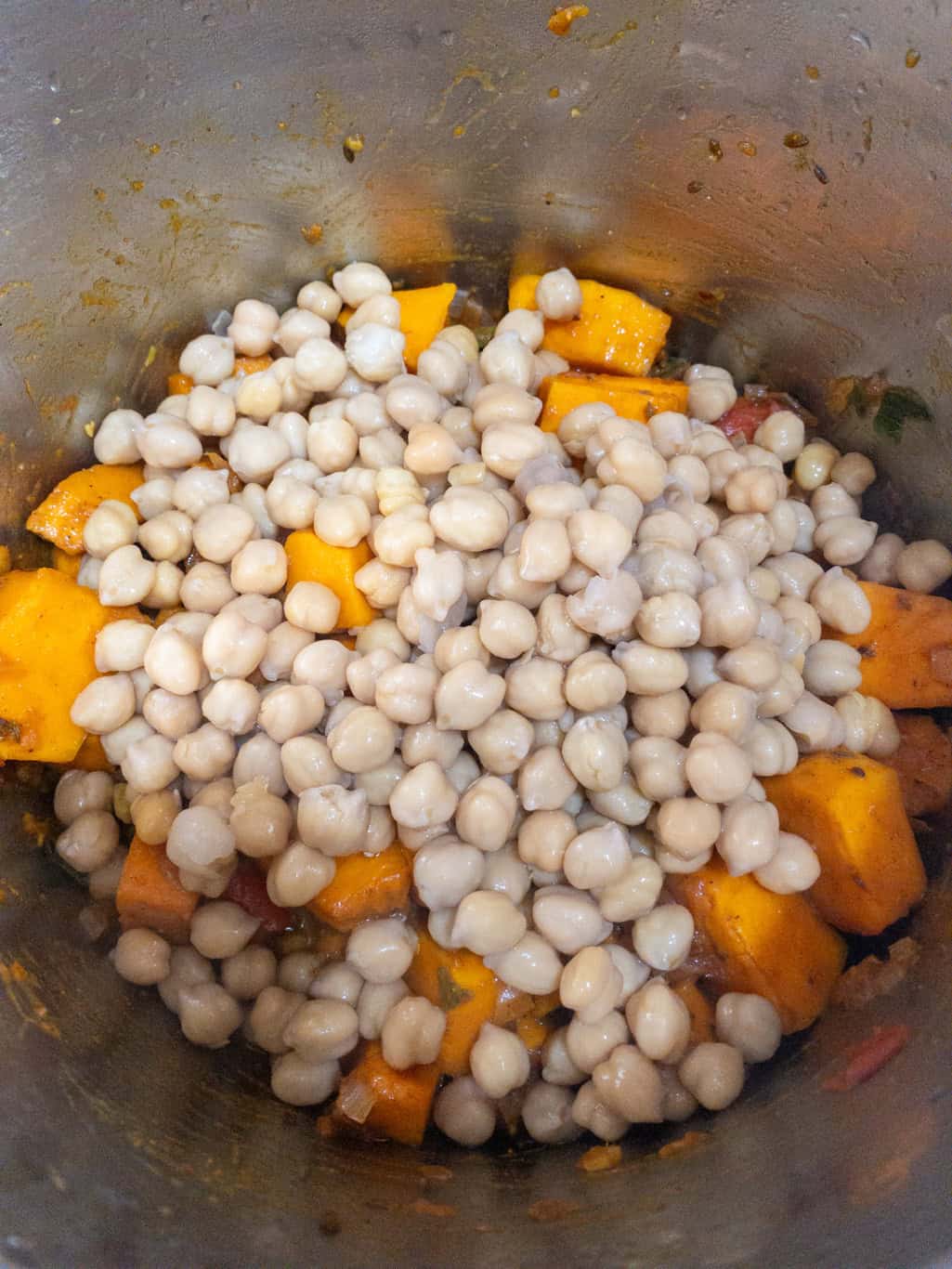 Cooked chickpeas added to the spiced pumpkin mixture in the Instant Pot.