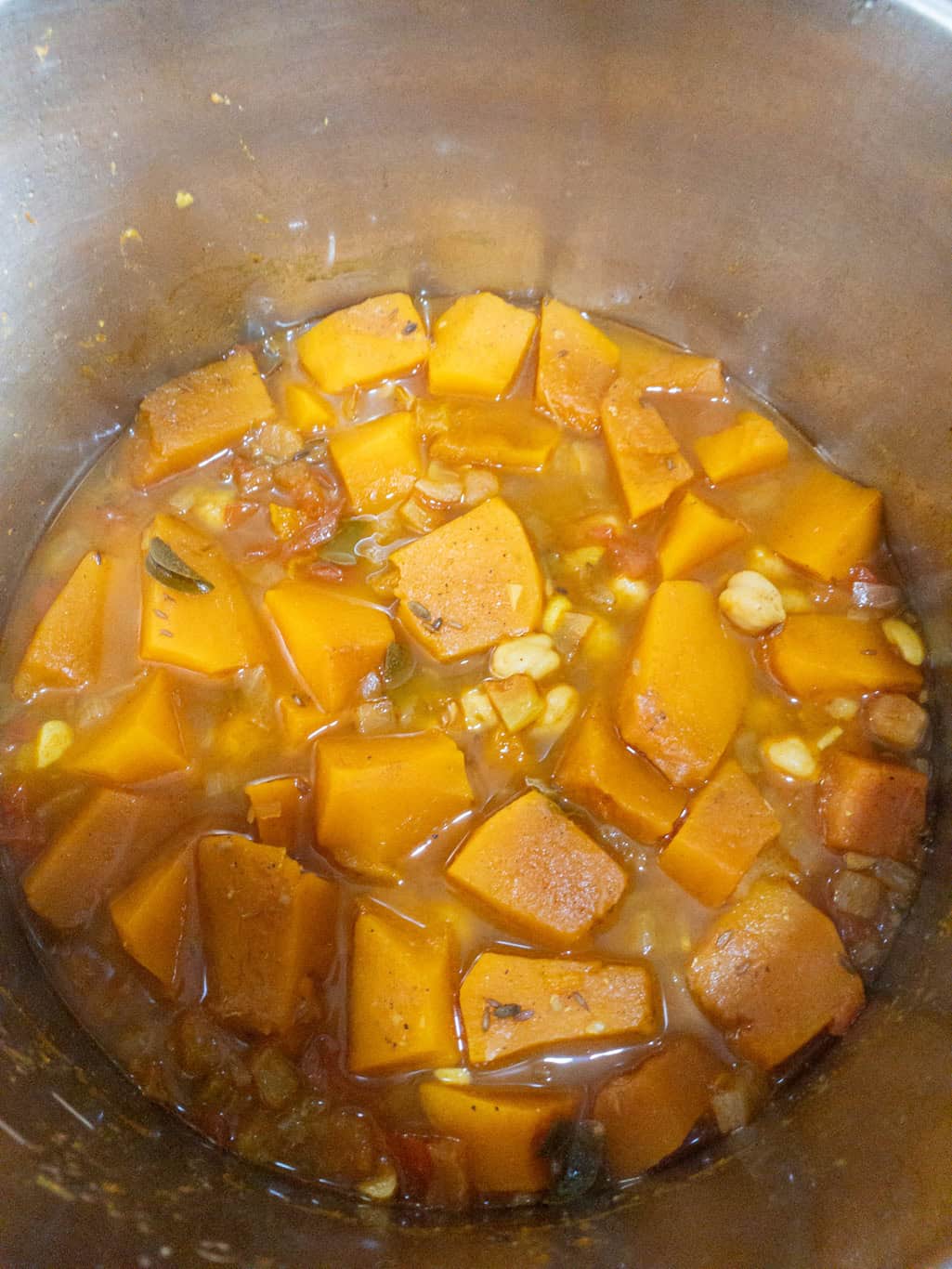 Cooked pumpkin chickpea curry after pressure cooking, showing tender pumpkin pieces in spiced gravy.