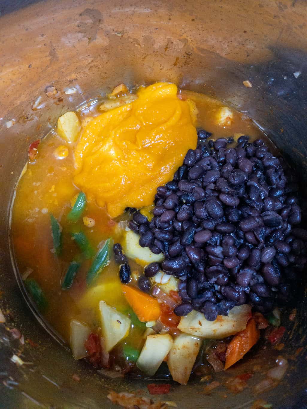 Pumpkin purรฉe and cooked black beans added to the sautรฉed vegetable mixture in the Instant Pot.
