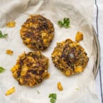 Close-up of cooked pumpkin black bean patties with crispy surface.