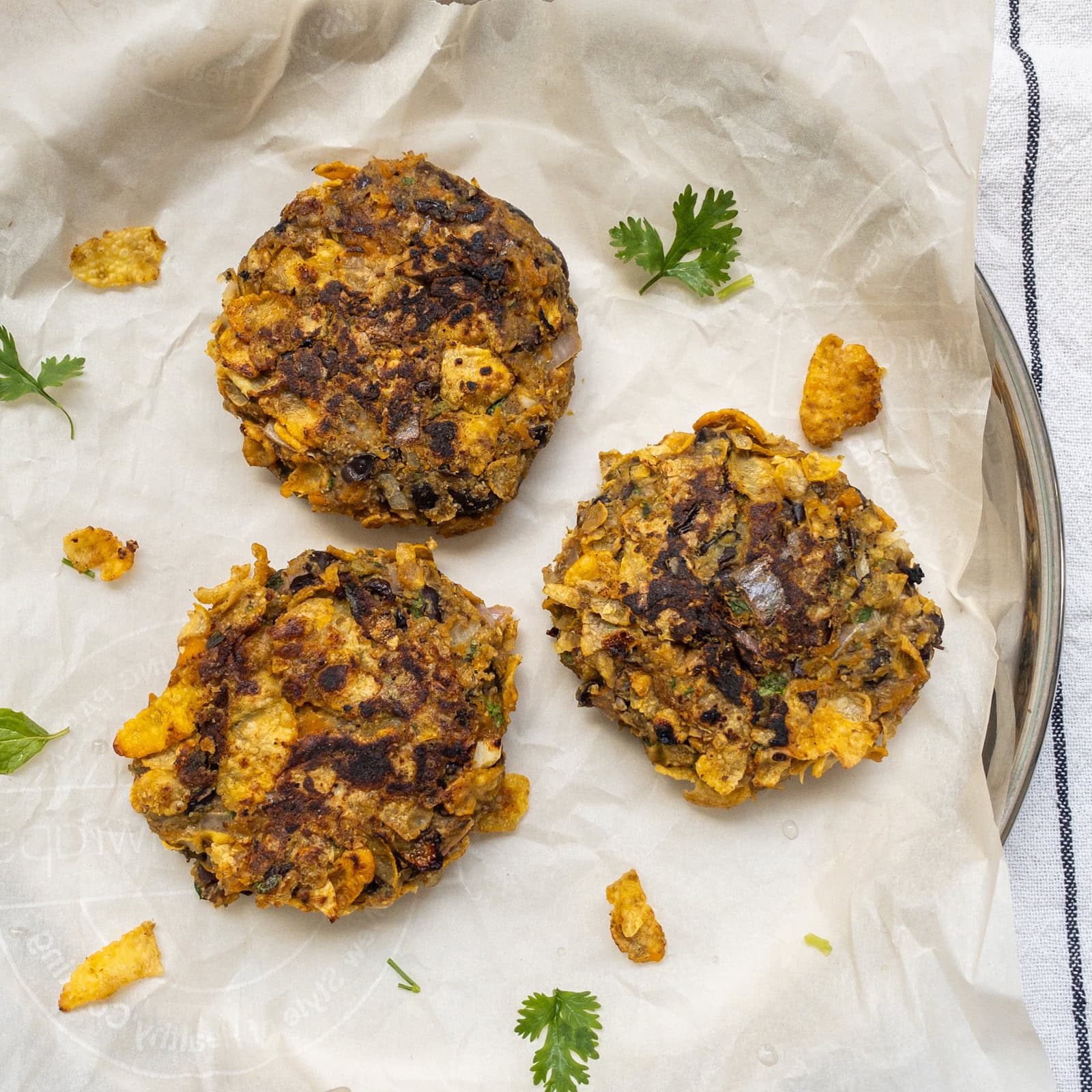 Close-up of cooked pumpkin black bean patties with crispy surface.