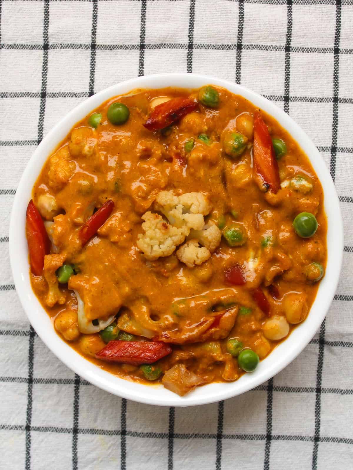 Creamy vegetable tikka masala with mixed vegetables and thick orange gravy.