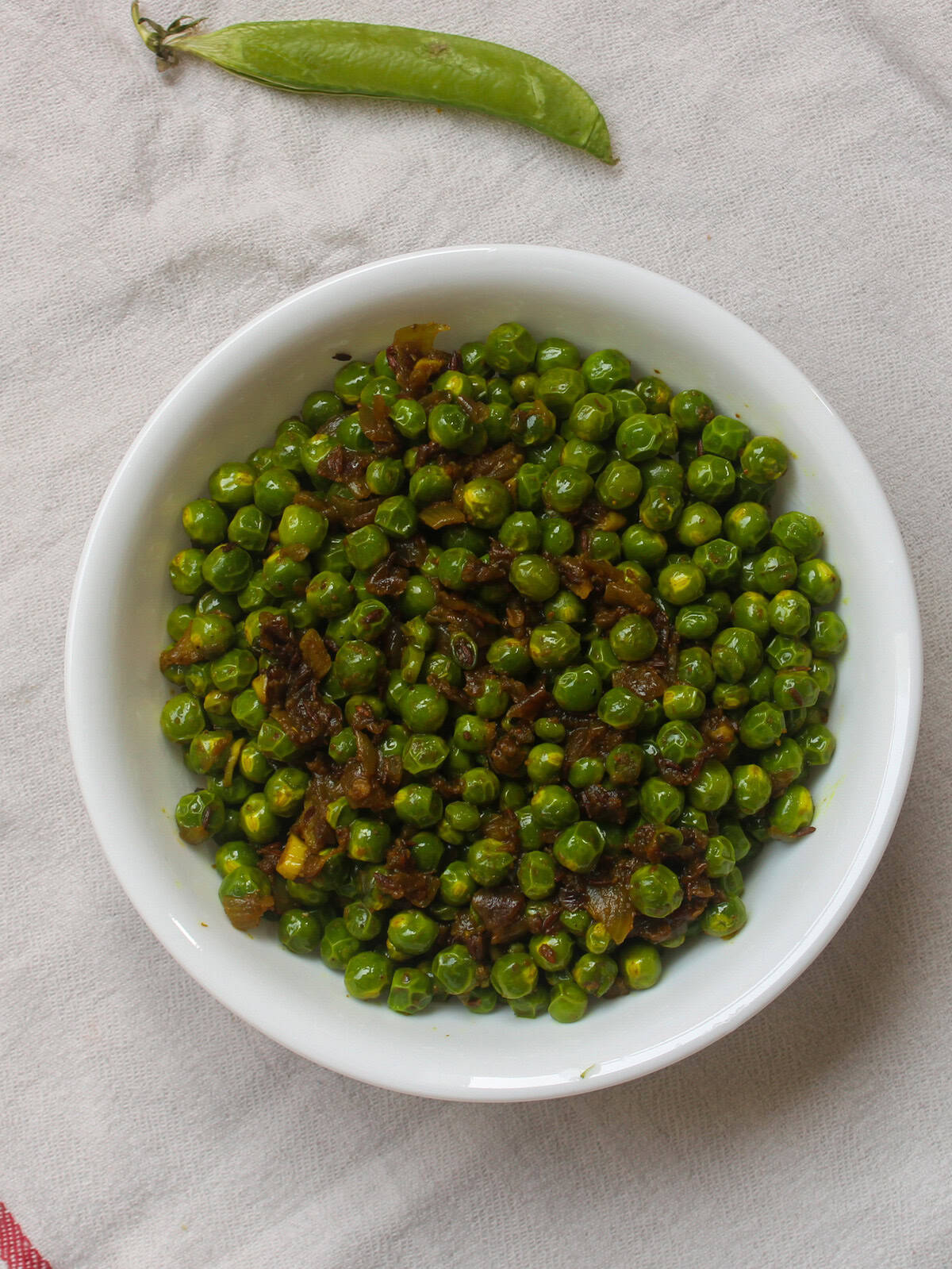 Finished Indian spiced sautรฉed green peas served as a simple side dish.