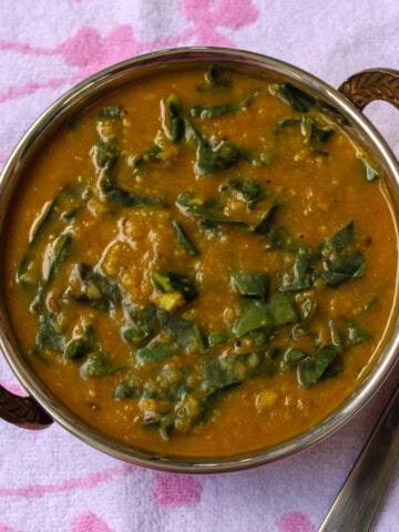 Close-up of creamy kale dal showing soft lentils and tender kale pieces.