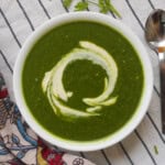 Creamy palak shorba served hot with a light swirl of cashew cream.