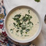 Close-up of creamy spinach raita showing yogurt texture and spices.