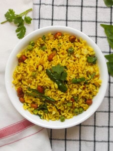 Top view of Indian fried rice with mustard seeds, peanuts, curry leaves, and fluffy basmati rice.