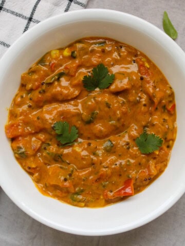 Close-up of 15-minute South Indian tomato curry without coconut or cream, garnished with fresh cilantro.