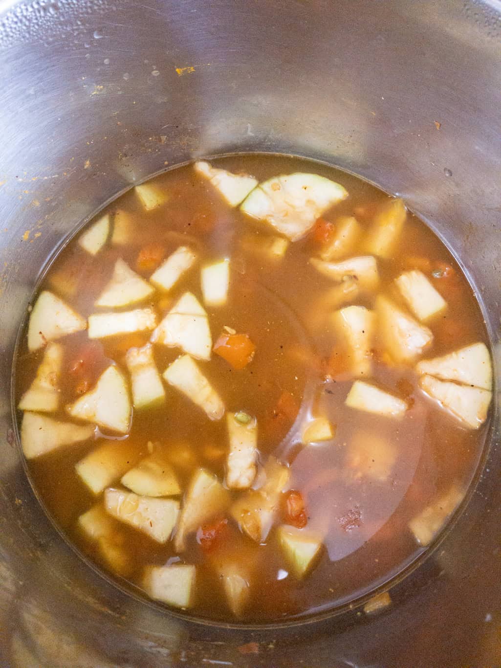 Water added to the Instant Pot with whole moong beans and bottle gourd, ready to pressure cook.