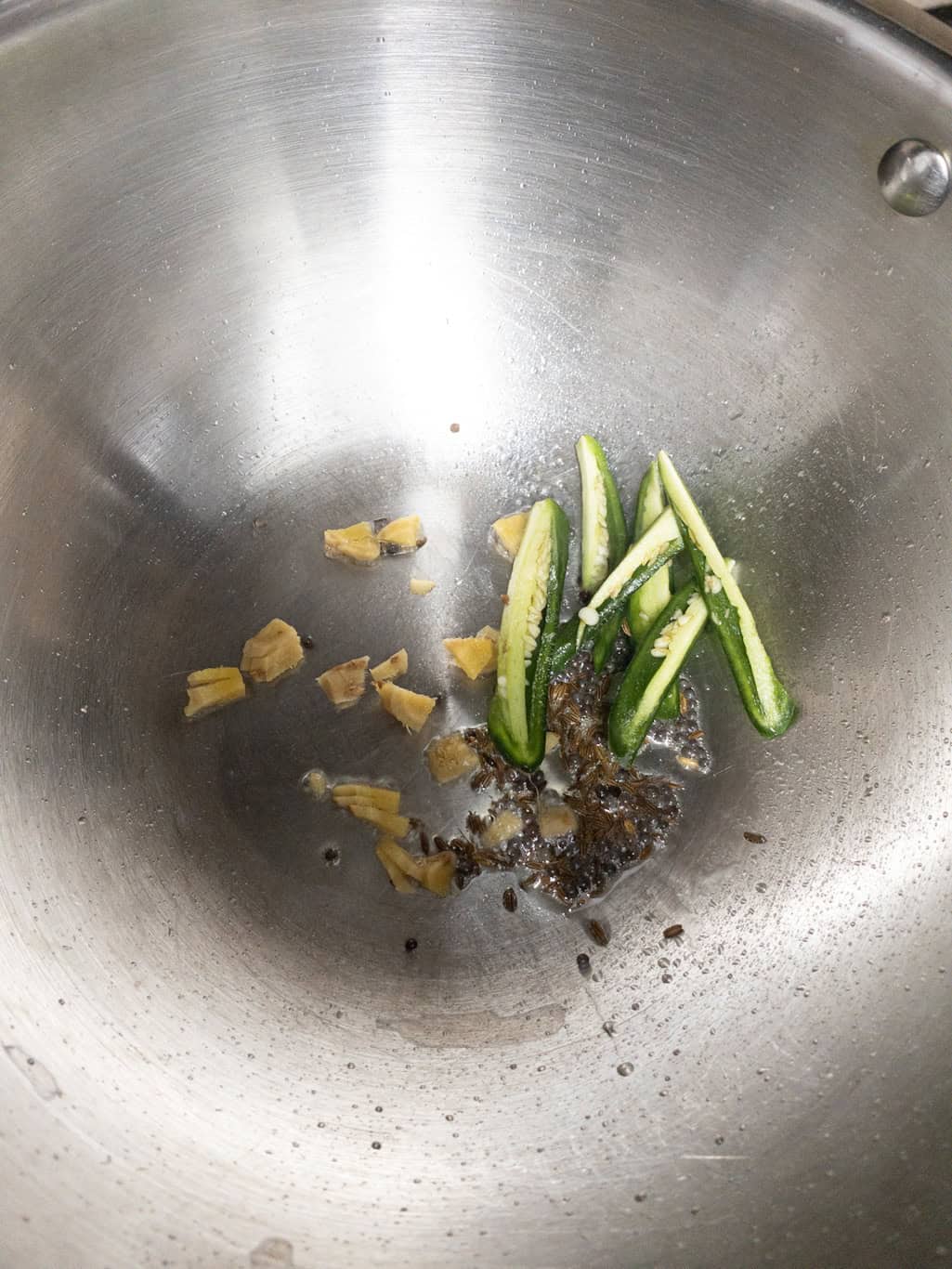 Chopped ginger and green chili added to the tempered spices.