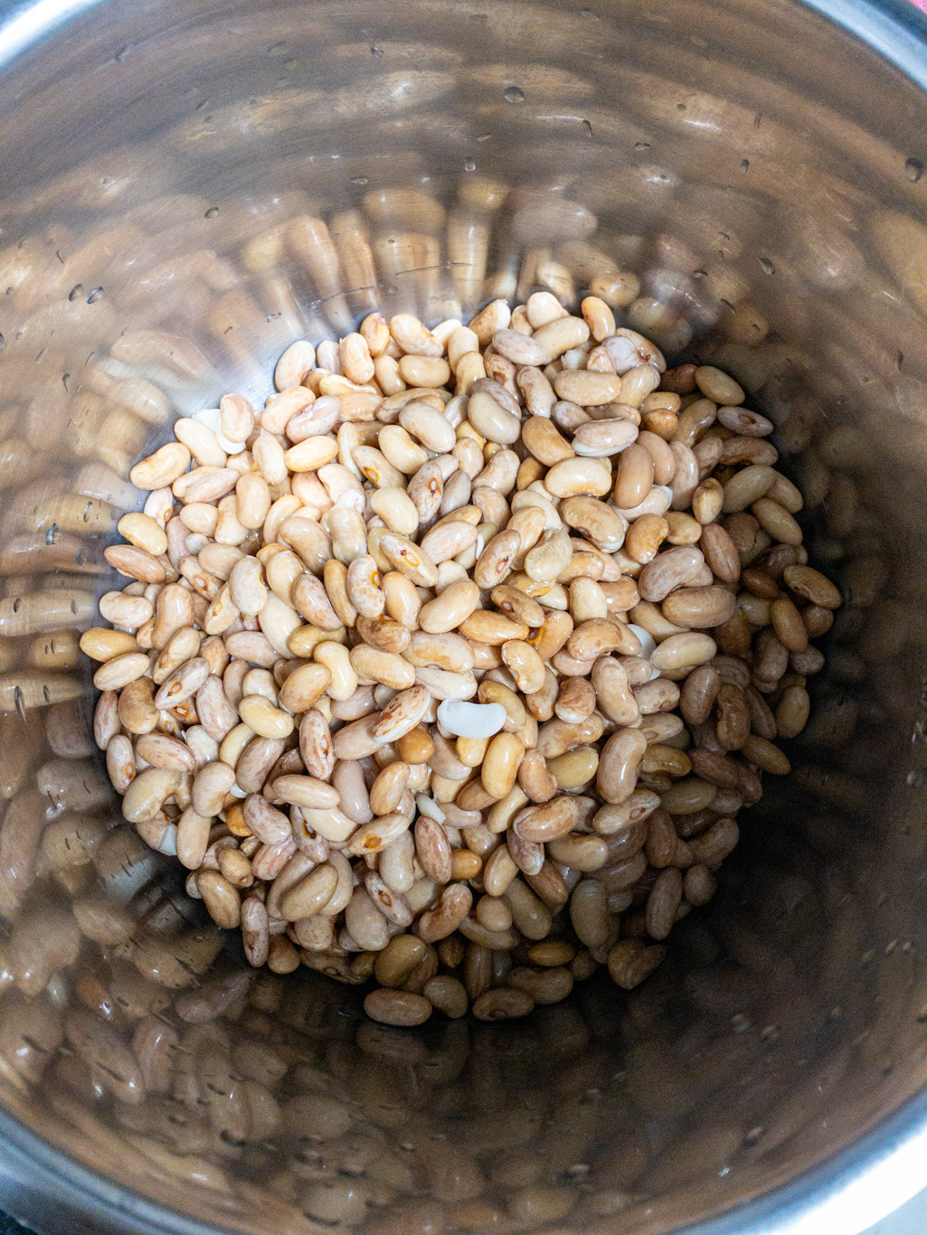 Soaked kidney beans are added to the Instant Pot inner pot before cooking.