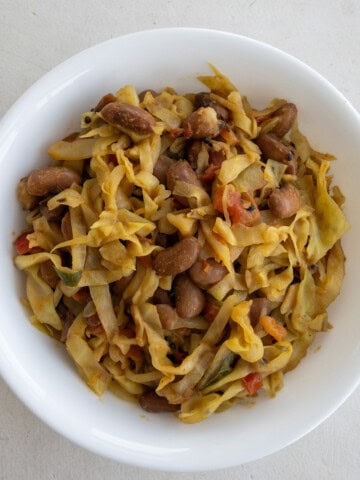 Indian cabbage stir fry with kidney beans served in a white bowl.