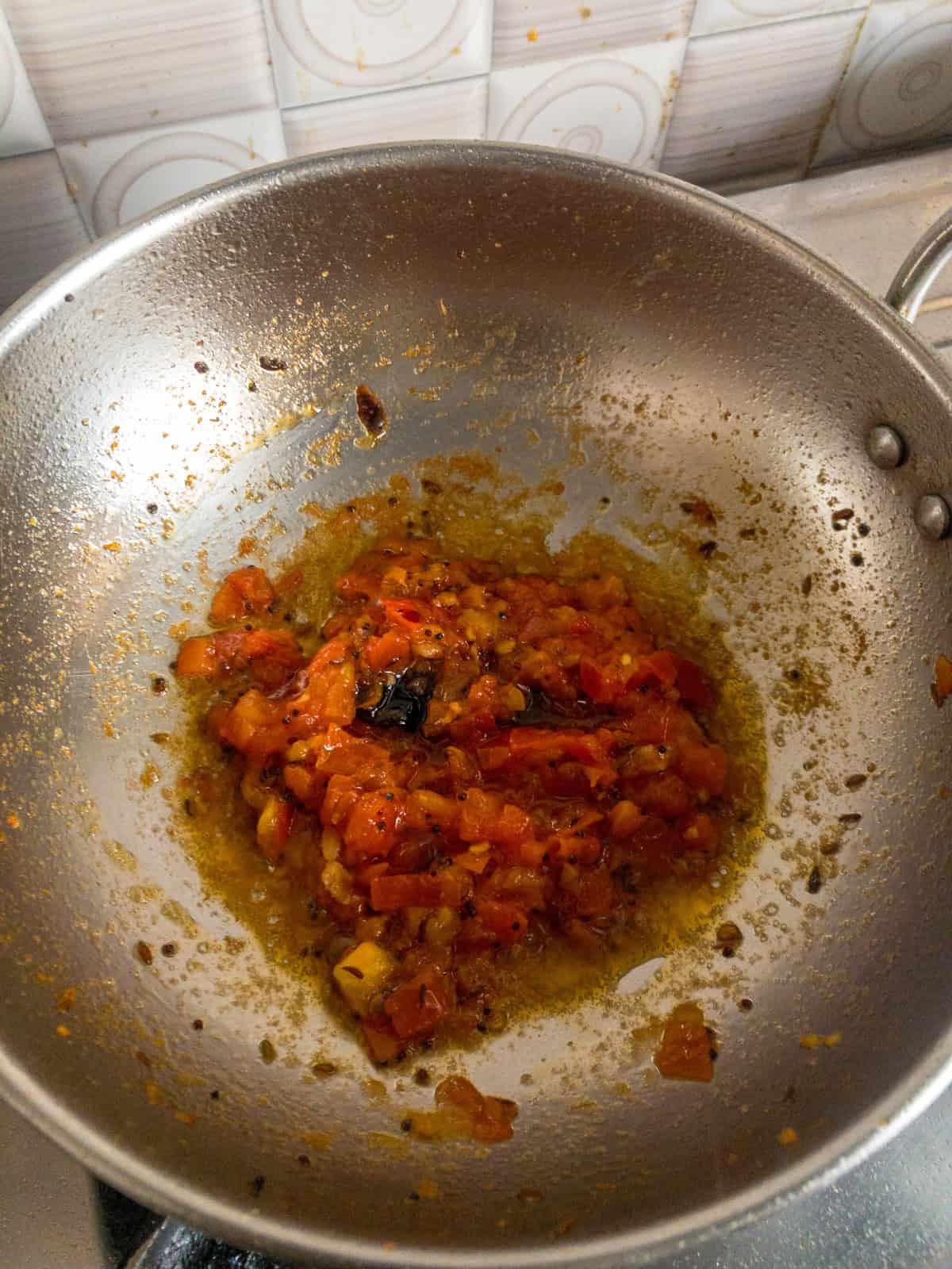 Tomatoes cooked down with mustard seeds, cumin seeds, ginger, and dried red chili for dal.