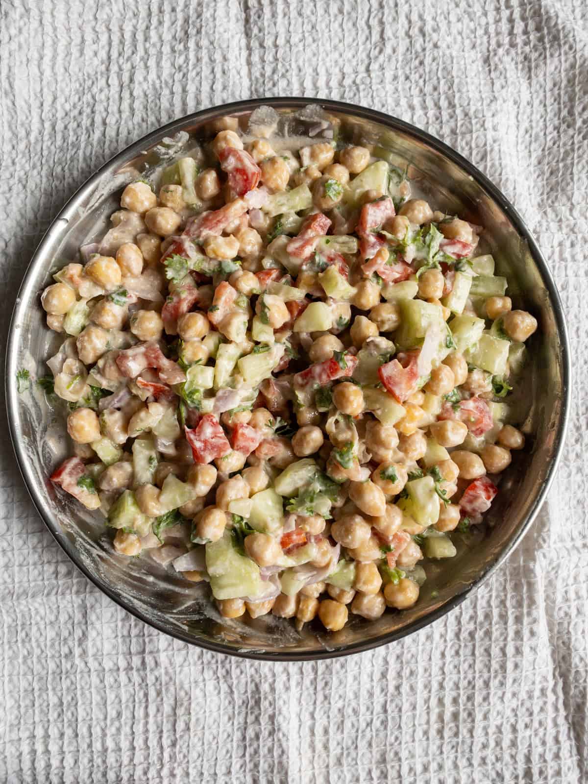 Chickpeas, cucumber, tomato, onion, and coriander coated evenly with creamy avocado yogurt dressing.