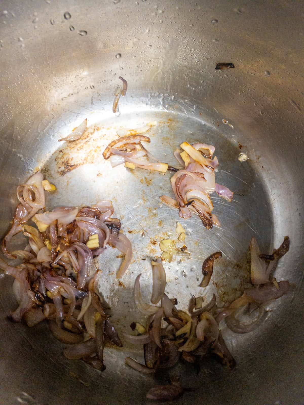 Browned onions with chopped ginger and garlic in the Instant Pot.