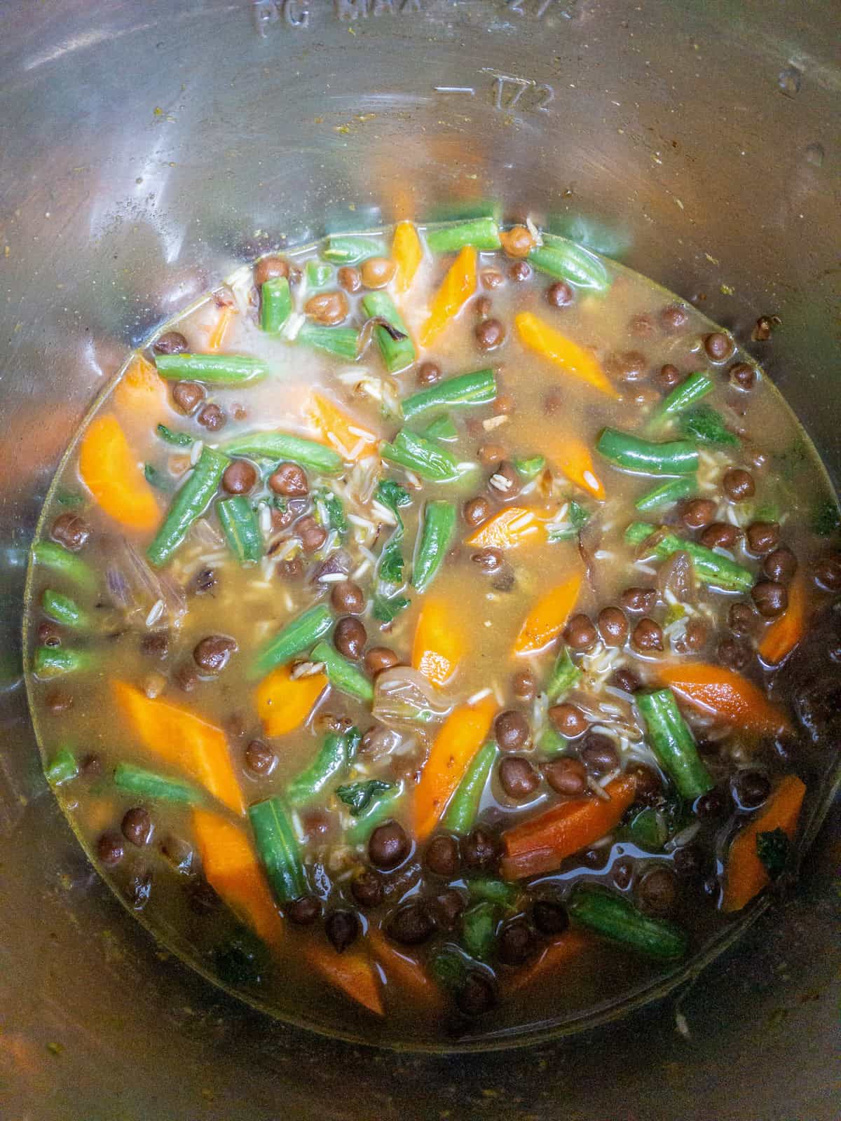 Water added to basmati rice, black chickpeas, carrots, and green beans before cooking.