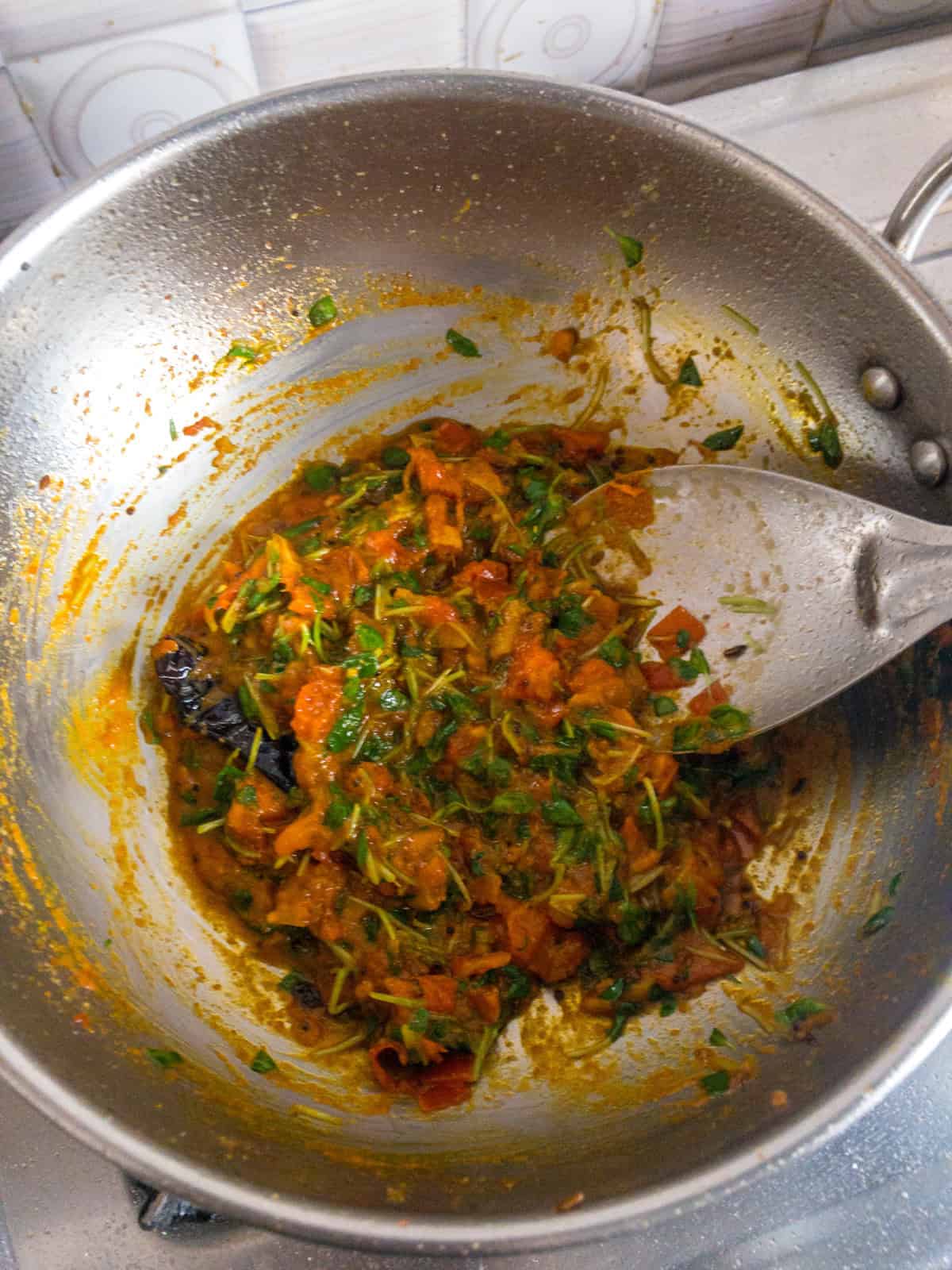 Cooked tomato and fresh fenugreek masala with spices for toor dal.